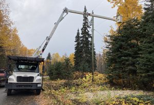 Vegetation crew using a truck to maintain trees close to power l