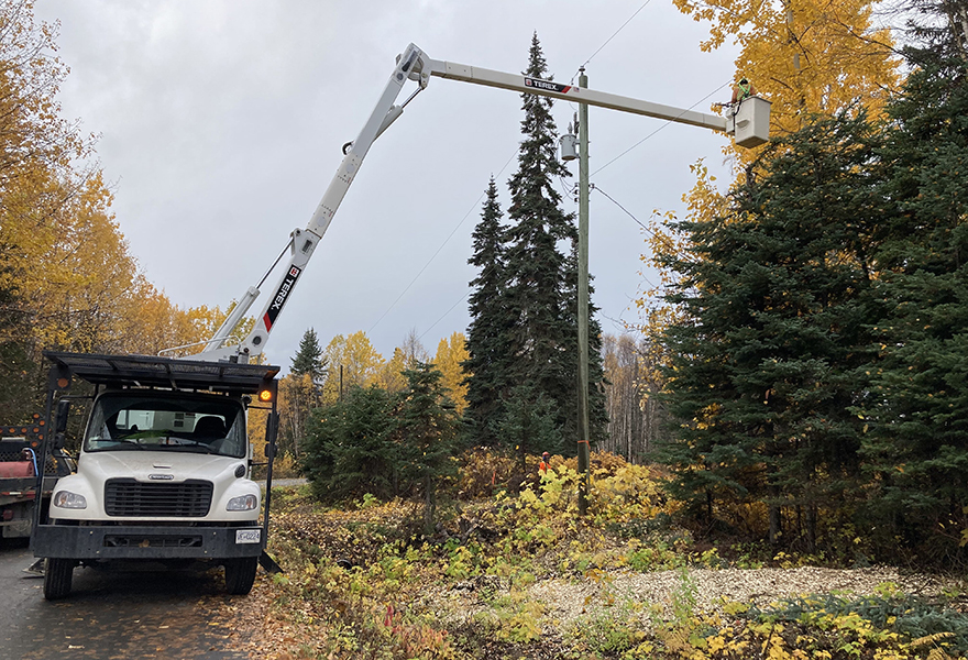 Vegetation crew using a truck to maintain trees close to power l