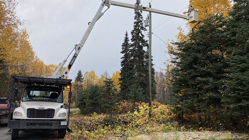 Vegetation crew using a truck to maintain trees close to power l